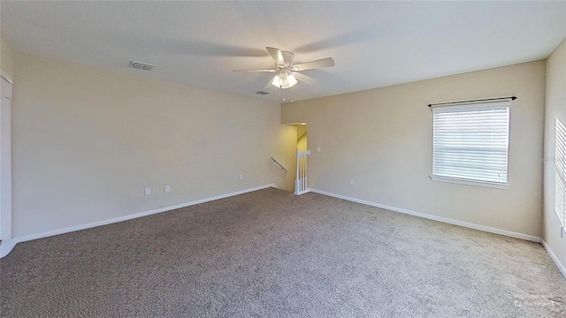 carpeted empty room featuring ceiling fan