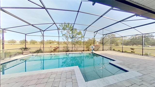 view of pool with a patio and a lanai