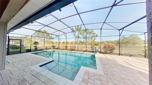 view of swimming pool with a patio area and a lanai