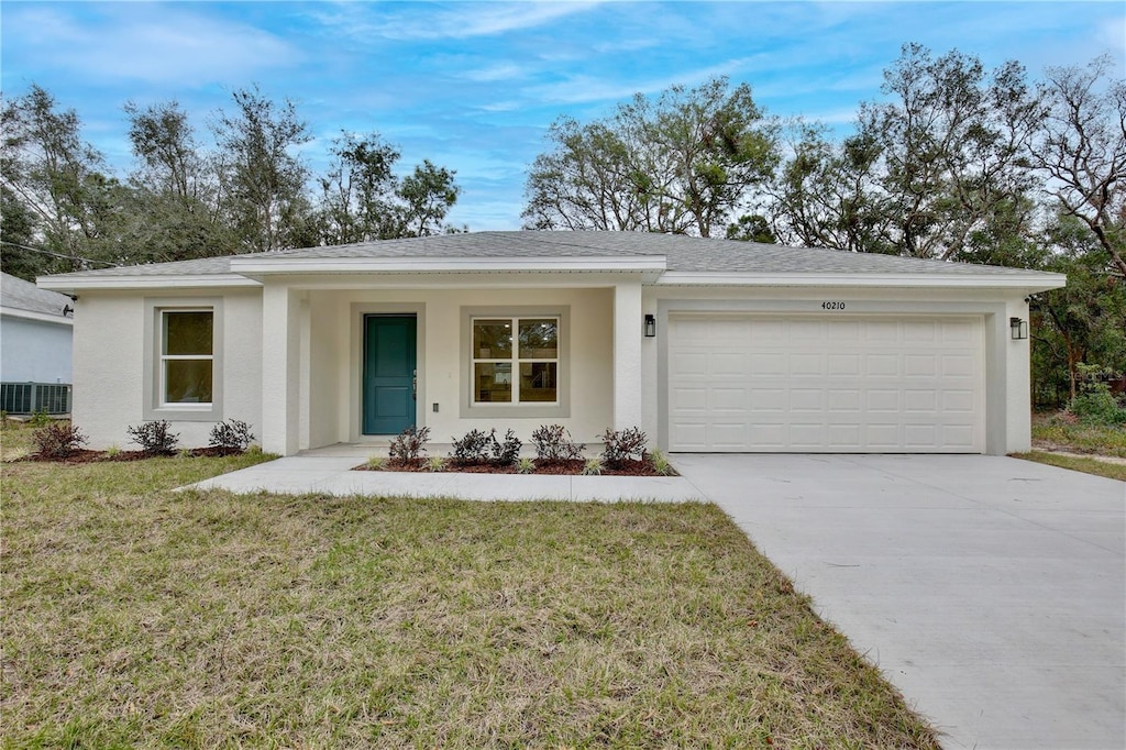 ranch-style home with a front lawn and a garage