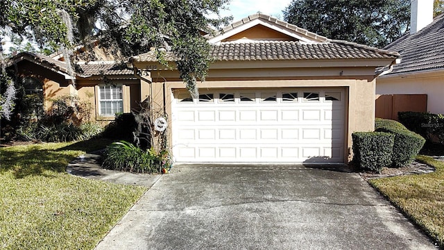 view of front of property featuring a front yard and a garage