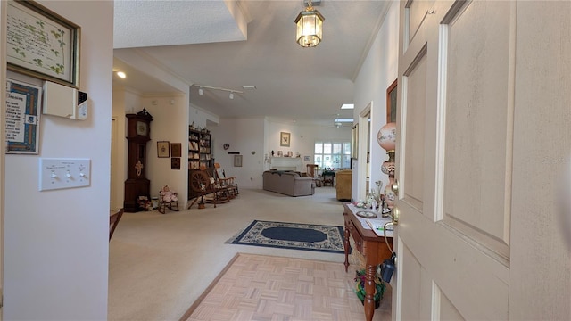 carpeted foyer with crown molding