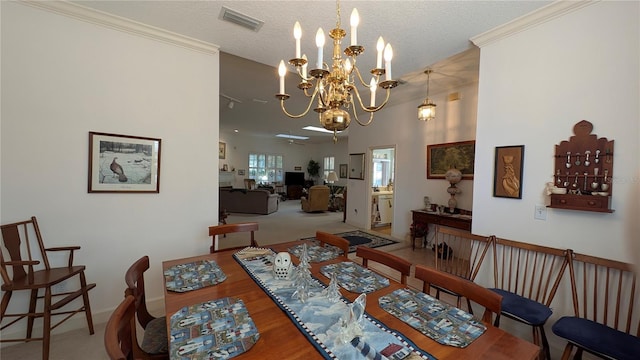 dining area with a textured ceiling, crown molding, and an inviting chandelier