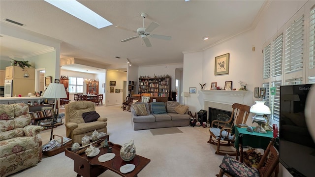 carpeted living room featuring ceiling fan, a skylight, and ornamental molding