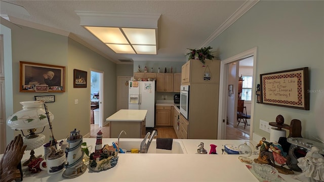 kitchen with white appliances, a kitchen island, light brown cabinetry, kitchen peninsula, and ornamental molding