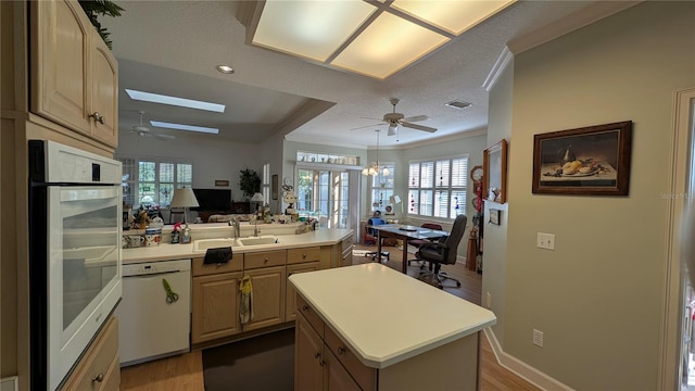 kitchen with sink, white appliances, a textured ceiling, a center island, and dark hardwood / wood-style floors