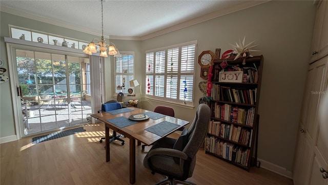 dining area featuring a healthy amount of sunlight, an inviting chandelier, and wood-type flooring