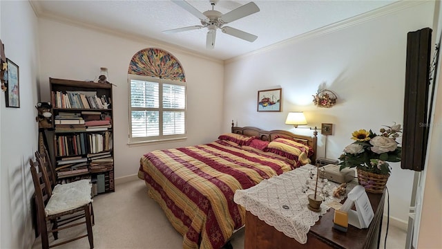 carpeted bedroom with ceiling fan and ornamental molding