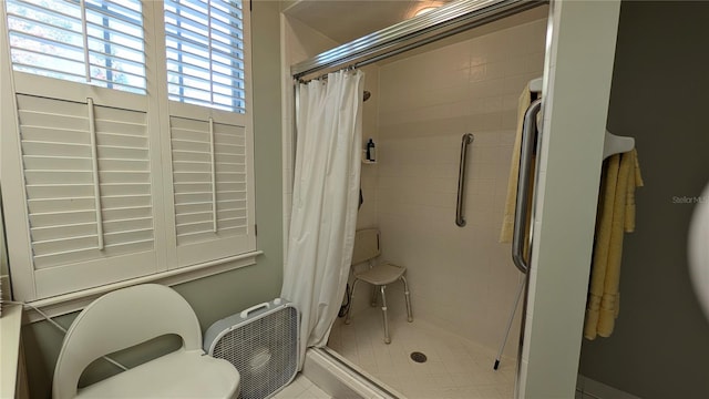 bathroom featuring walk in shower and tile patterned flooring