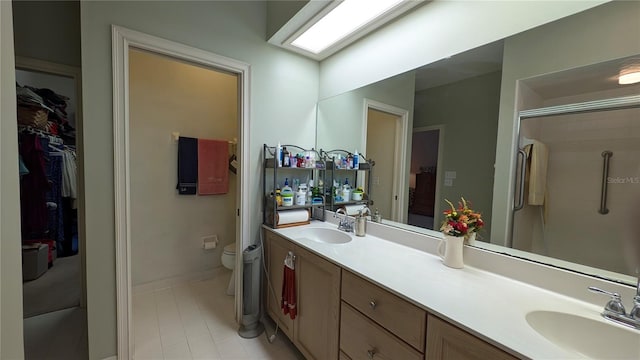 bathroom with a shower with shower door, toilet, and vanity