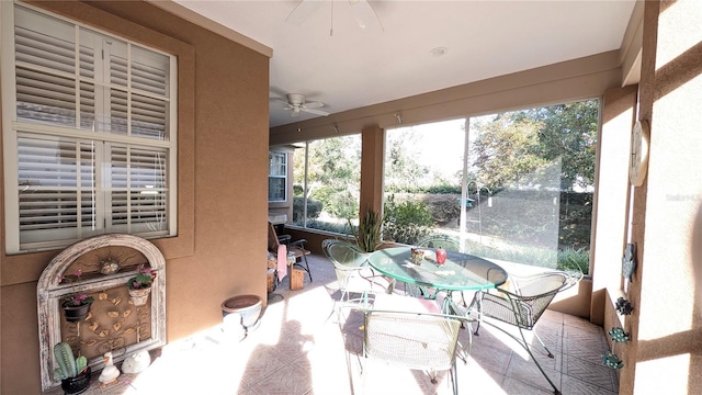 sunroom featuring ceiling fan