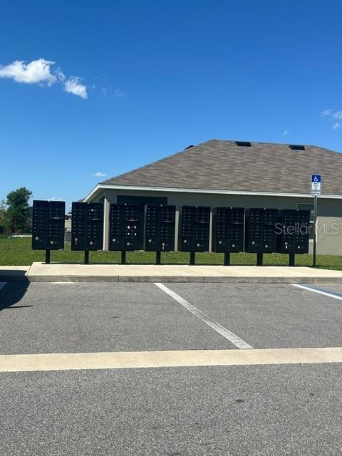 view of car parking with a mail area