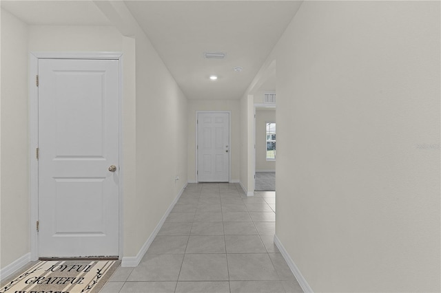 hall with light tile patterned floors