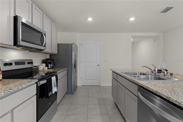 kitchen with white cabinetry, sink, light tile patterned floors, and appliances with stainless steel finishes