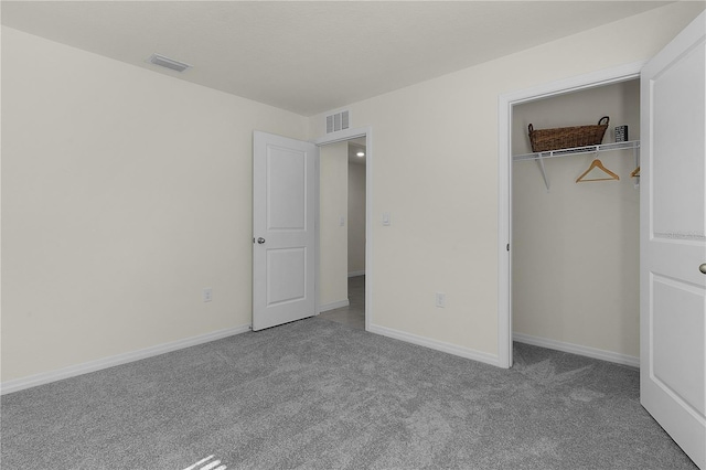 unfurnished bedroom featuring carpet floors and a closet