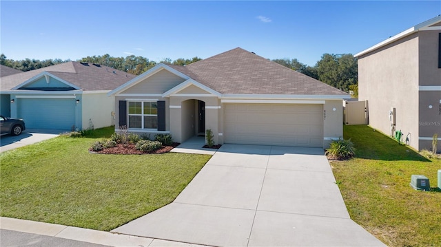 view of front of home featuring a garage and a front yard