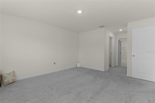 unfurnished room featuring light carpet