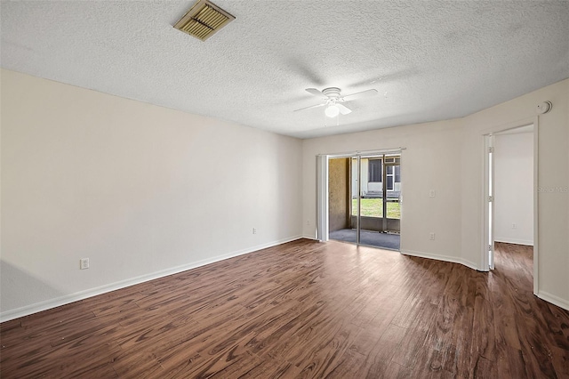 spare room with a textured ceiling, ceiling fan, and dark hardwood / wood-style floors