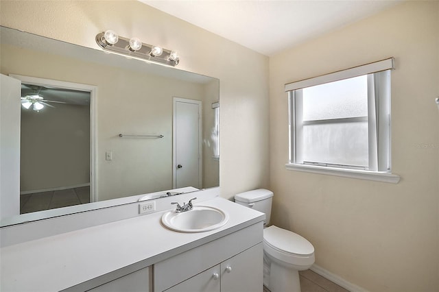 bathroom with toilet, vanity, tile patterned flooring, and ceiling fan