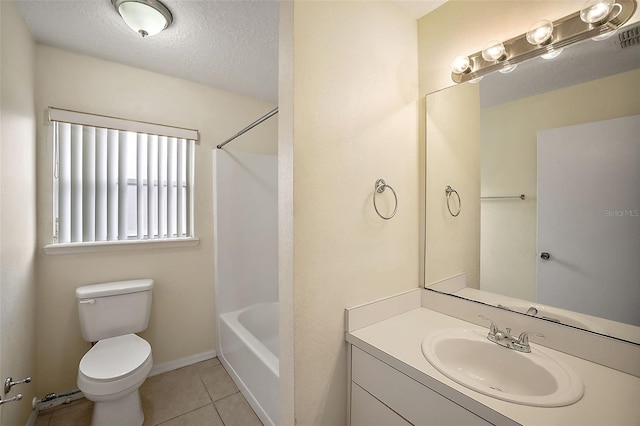 bathroom featuring toilet, vanity, tile patterned floors, and a textured ceiling