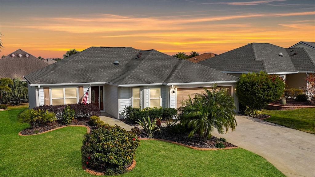 view of front of home featuring a garage and a lawn