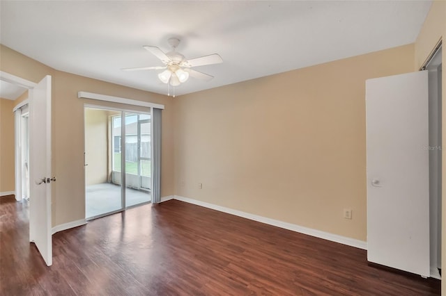 spare room featuring ceiling fan and dark wood-type flooring