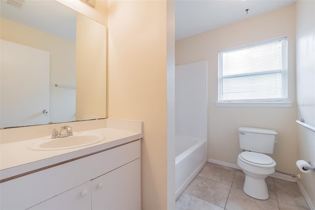 bathroom featuring toilet, vanity, and tile patterned flooring