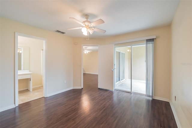 spare room featuring ceiling fan and dark wood-type flooring