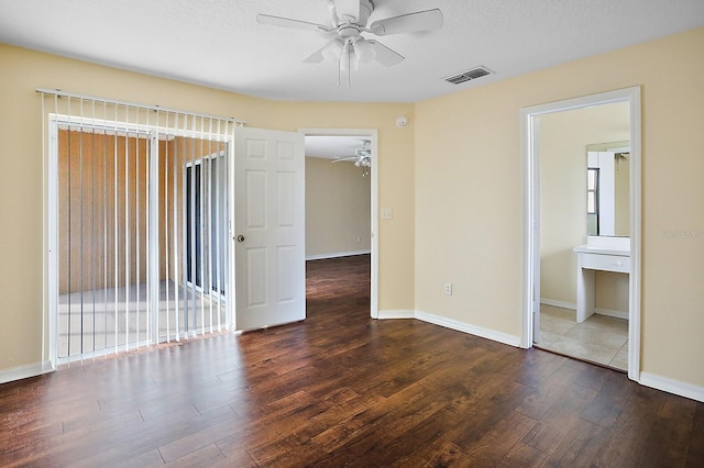 spare room featuring ceiling fan and dark hardwood / wood-style flooring