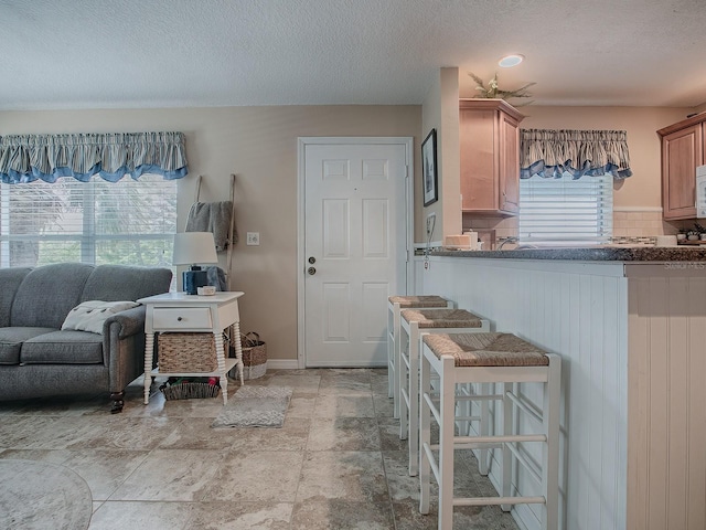 kitchen with decorative backsplash and a textured ceiling