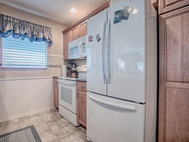 kitchen with light tile patterned flooring and white appliances