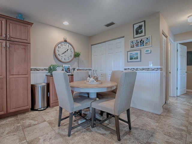 dining room with a textured ceiling and electric panel