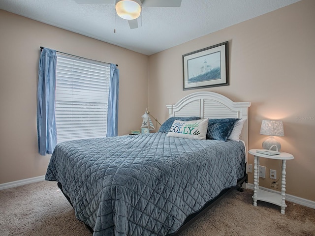 carpeted bedroom with ceiling fan and a textured ceiling