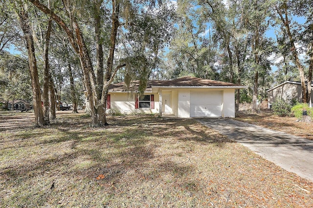 single story home with a front yard and a garage