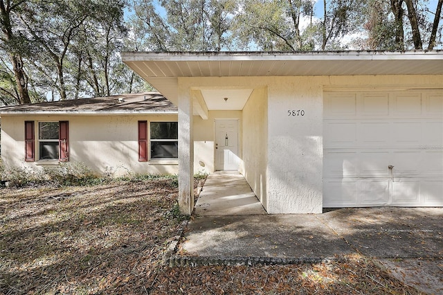 view of exterior entry featuring a garage