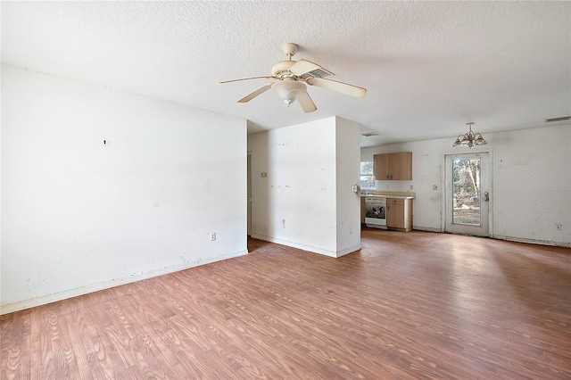 unfurnished living room featuring a textured ceiling, ceiling fan, and hardwood / wood-style floors