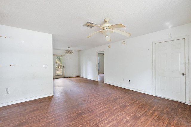 spare room with a textured ceiling, dark wood-type flooring, and ceiling fan with notable chandelier