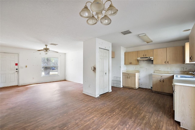 kitchen featuring ceiling fan with notable chandelier, dark wood-type flooring, light brown cabinets, and sink