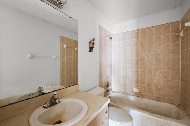 full bathroom with toilet, vanity, and tiled shower / bath combo