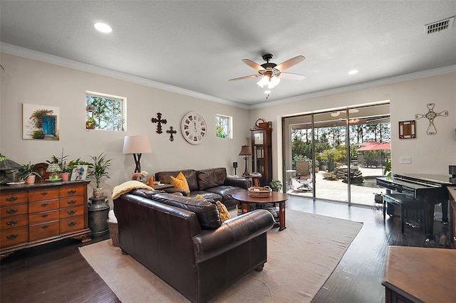 living room with ceiling fan, a healthy amount of sunlight, ornamental molding, and dark hardwood / wood-style flooring