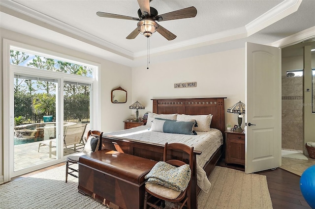 bedroom with dark hardwood / wood-style flooring, access to outside, ornamental molding, ceiling fan, and a tray ceiling