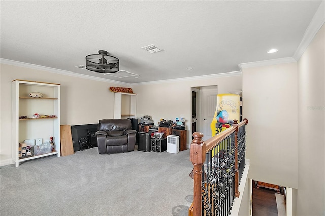 sitting room with carpet, crown molding, and a textured ceiling