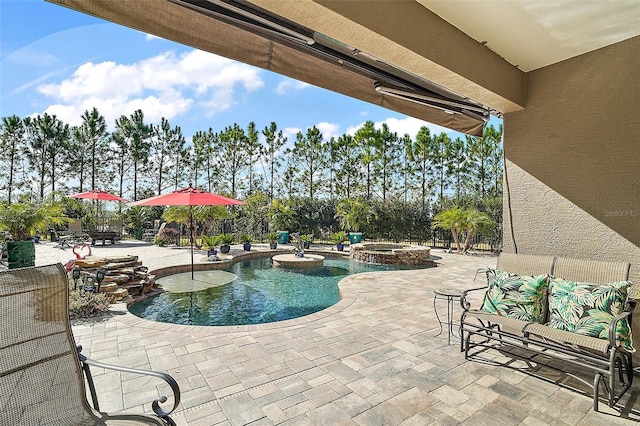 view of swimming pool featuring an in ground hot tub and a patio area