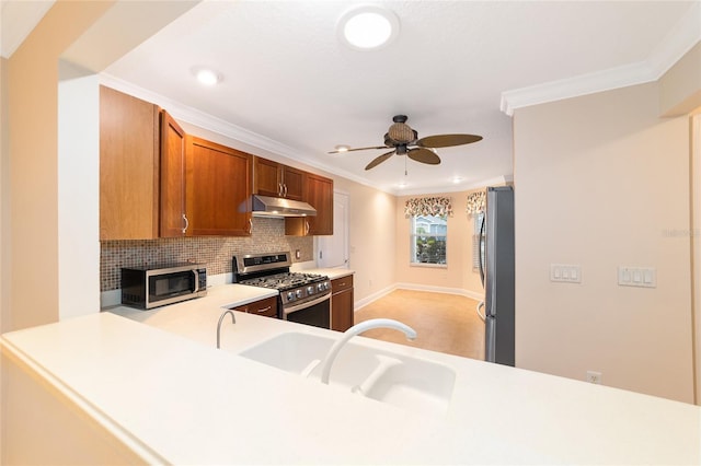 kitchen featuring tasteful backsplash, sink, kitchen peninsula, stainless steel appliances, and crown molding