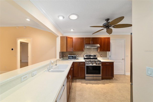 kitchen featuring dishwasher, sink, stainless steel range with gas stovetop, and crown molding