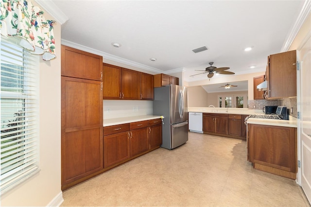 kitchen featuring dishwasher, crown molding, backsplash, and stainless steel refrigerator