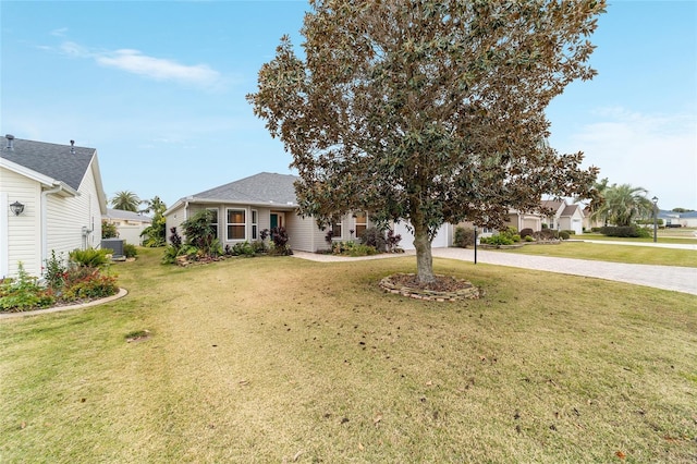 view of front of house with central AC unit and a front lawn