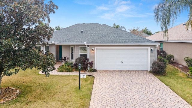 ranch-style home with a garage and a front yard