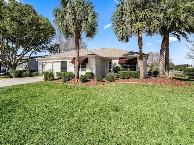 ranch-style house with a garage and a front yard