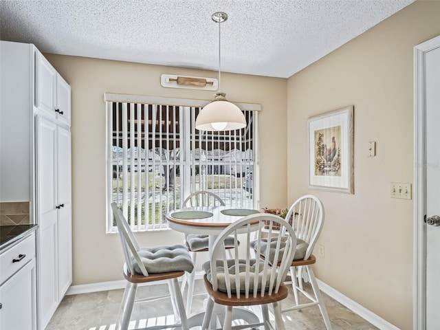 dining space featuring a textured ceiling